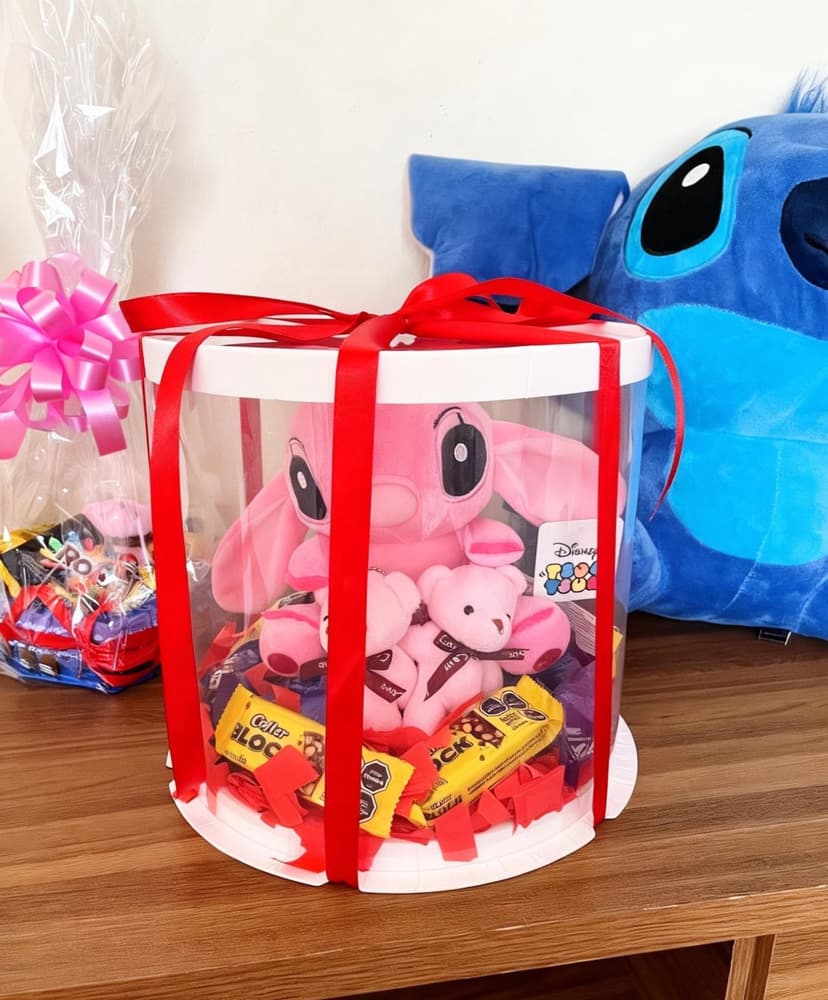 Caja cilindro transparente con peluche rosa y chocolates